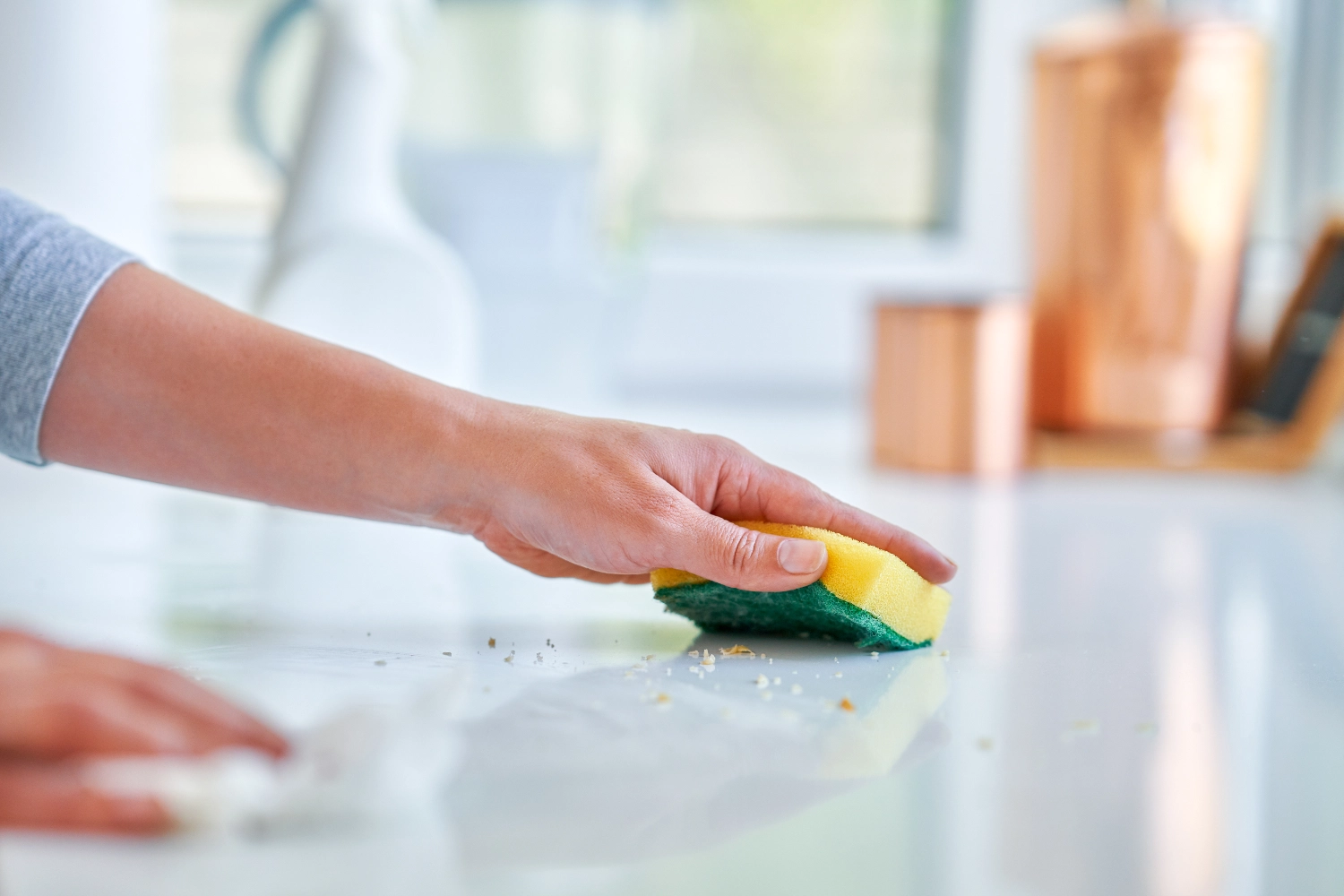 young-woman-cleaning-dirt-in-the-kitchen